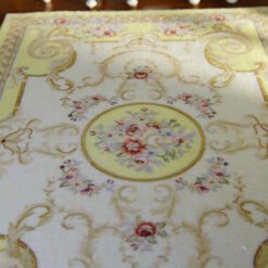 Light yellow Victorian rug with floral motifs and golden accents