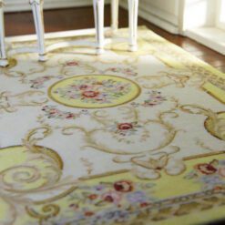 Light yellow Victorian rug with floral motifs and golden accents