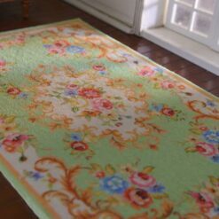 Victorian Rococo miniature rug with light green background and floral scrolls