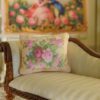 Miniature pillow with pink and red roses framed by golden floral accents
