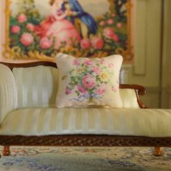 Miniature pillow with pink and yellow rose bouquet tied with blue ribbon