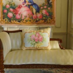 Miniature pillow with pink roses and yellow flowers framed by ornate gold