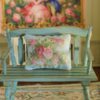 Miniature pillow featuring pink and red roses with golden scroll accents