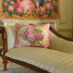 Miniature pillow with red and pink roses framed by golden scrolls