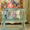 Miniature pillow with a rabbit couple in vintage attire surrounded by pink roses
