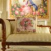 Miniature pillow with a pink rose bouquet tied with a pink ribbon and golden frame