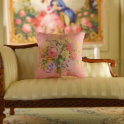 Miniature pillow with pink and yellow flowers tied with a blue ribbon