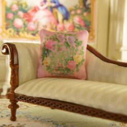 Miniature pillow with a wreath of pink, yellow, and lavender roses
