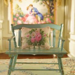 Miniature pillow featuring pink roses and white flowers in green foliage