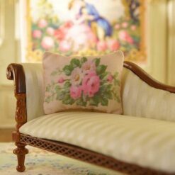 Miniature pillow featuring pink roses and white flowers in green foliage