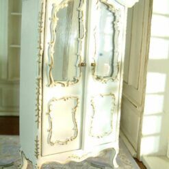 White dollhouse wardrobe with mirrored doors and gold embellishments