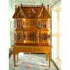 Victorian-style dollhouse cabinet in walnut finish with two-drawer table