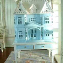 Victorian-style dollhouse cabinet in pastel blue on a white table