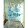 Victorian-style dollhouse cabinet in pastel blue on a white table