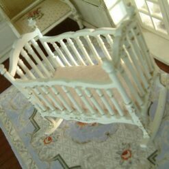 Victorian-style miniature rocking crib in white