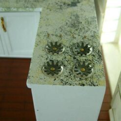 White dollhouse kitchen cabinet with marble-style countertop