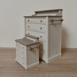 A vintage-style dollhouse chest of drawers with five compartments.