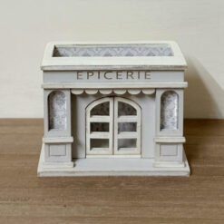A miniature grocery store display for dollhouses with detailed wallpaper.