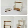 A miniature jam and cup rack for dollhouse kitchens.