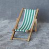 Miniature Striped Beach Chairs Set – Red, Blue, Green, Yellow 1 Set of four miniature beach chairs with striped fabric in red, blue, green, and yellow for dollhouses.