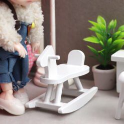 Miniature nursery furniture set including crib, cradle, high chair, and more.