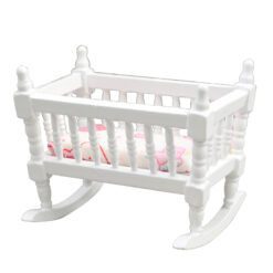 Miniature wooden rocking cradle for dollhouse nursery.