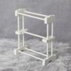 Miniature white towel rack made from wood and bamboo for dollhouse bathrooms.