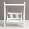 Miniature swing with a white frame and golden chains