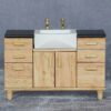 Miniature sink cabinet with black countertop and gold faucets for dollhouse bathrooms.