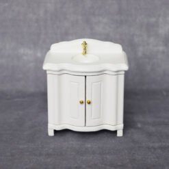Miniature white vanity sink for dollhouse bathroom.