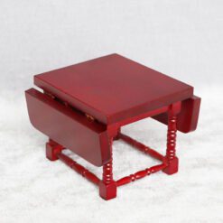Miniature wooden dining table with intricate design for dollhouses.