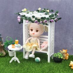 White miniature garden arbor with slatted bench, perfect for dollhouse outdoor scenes.