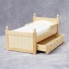 Miniature wooden bed with green bedding for dollhouse